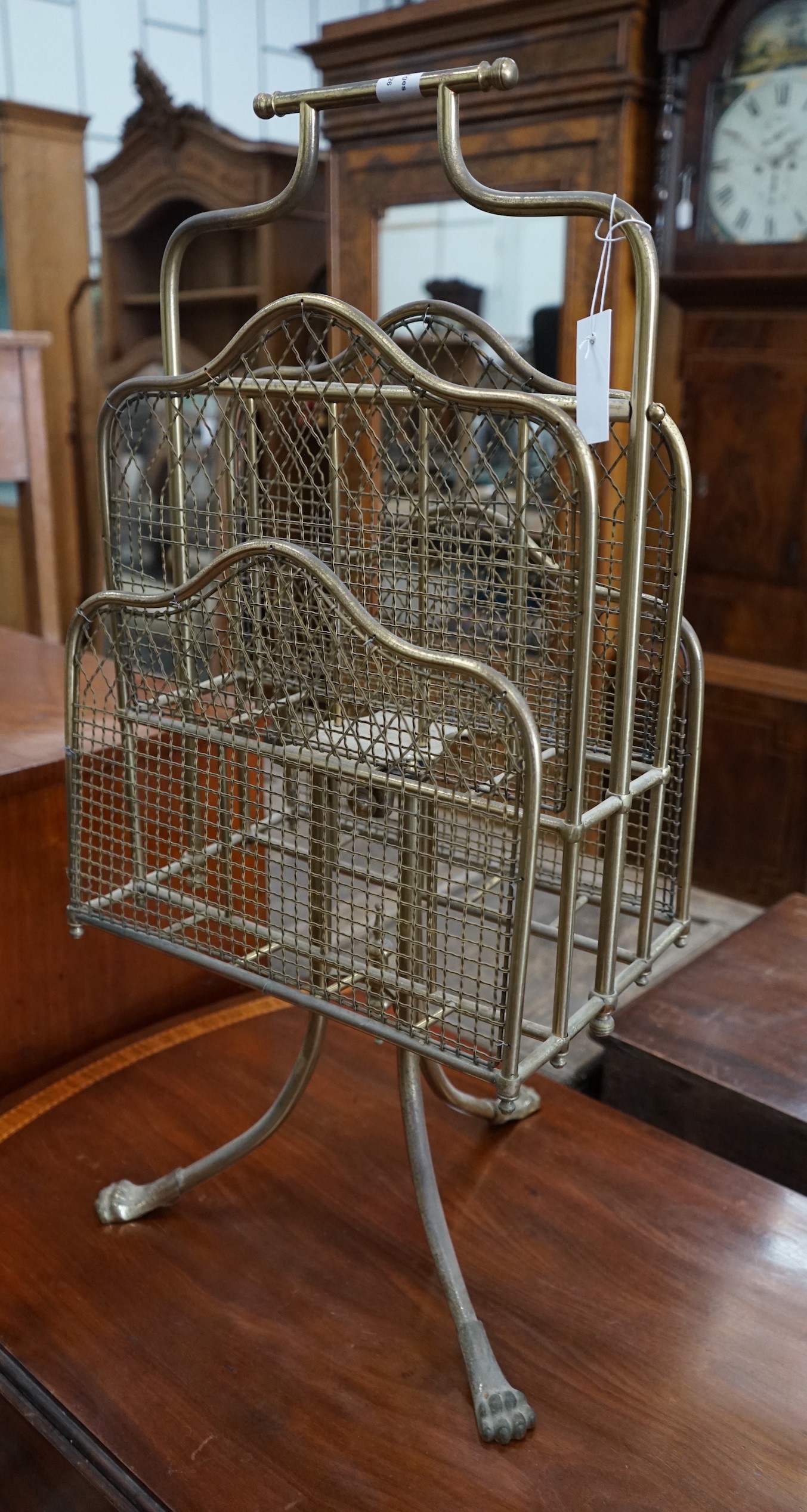 An Edwardian gilt metal wirework four division magazine rack